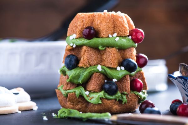 Decorating Christmas tree cake with fresh winter berry fruits