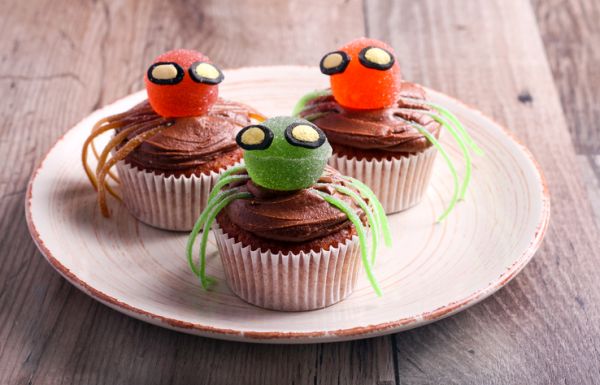 Halloween decorated sweet spider cupcakes on plate